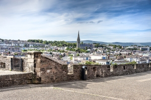 Londonderry, Northern Ireland: Skyline of Derry with St. Eugene's Cathedral near Free Derry Corner, city wall. horizon and blue sky